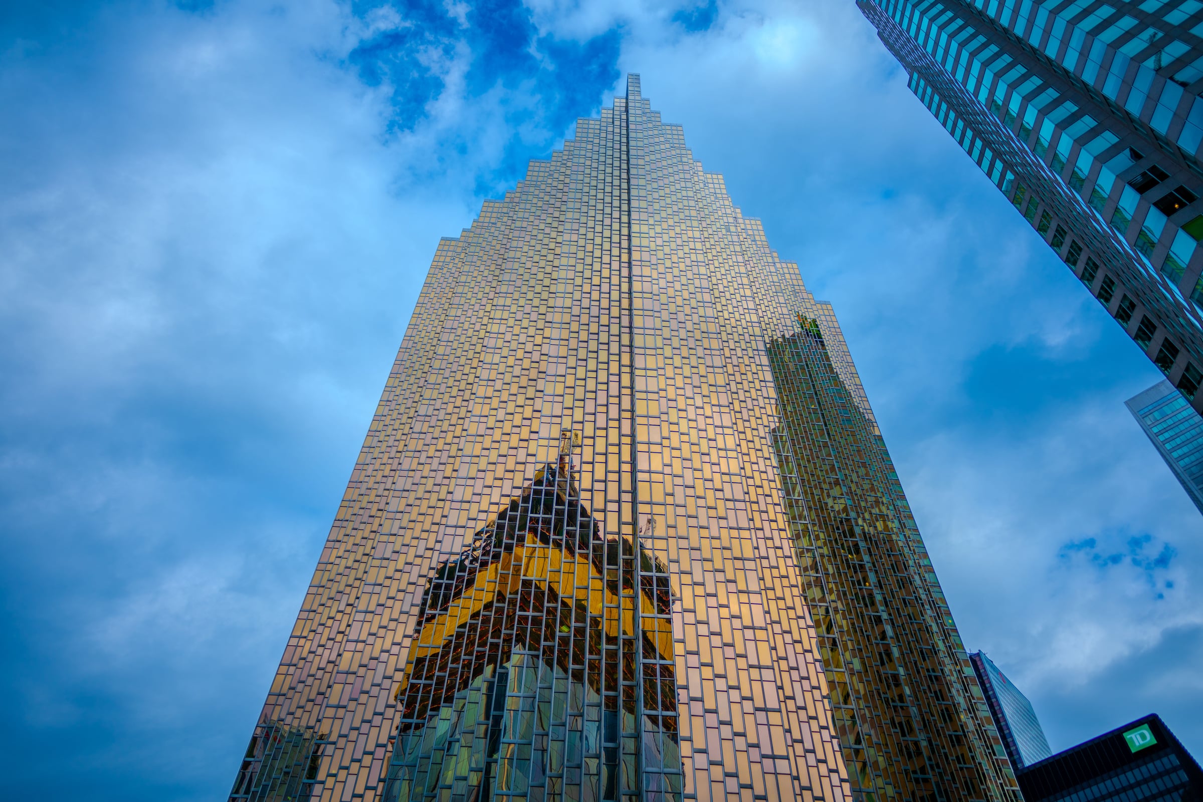 A tall reflective Toronto building seen from street level.